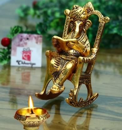 Trendhubs Golden Lord Ganesha Statue Sitting On A Rocking Chair And Reading Ramayan Showpiece